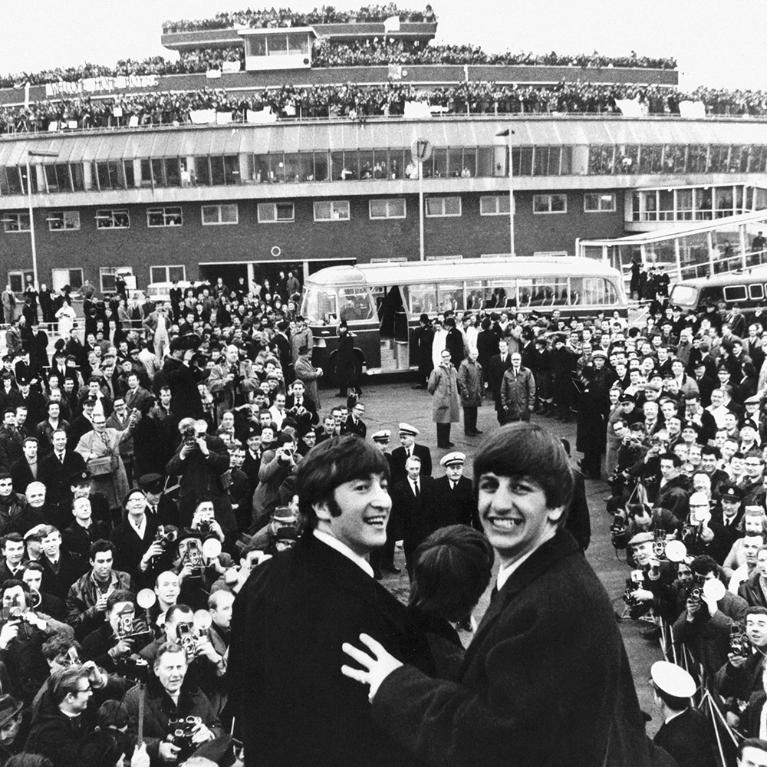Beatles surrounded by thousands of fans