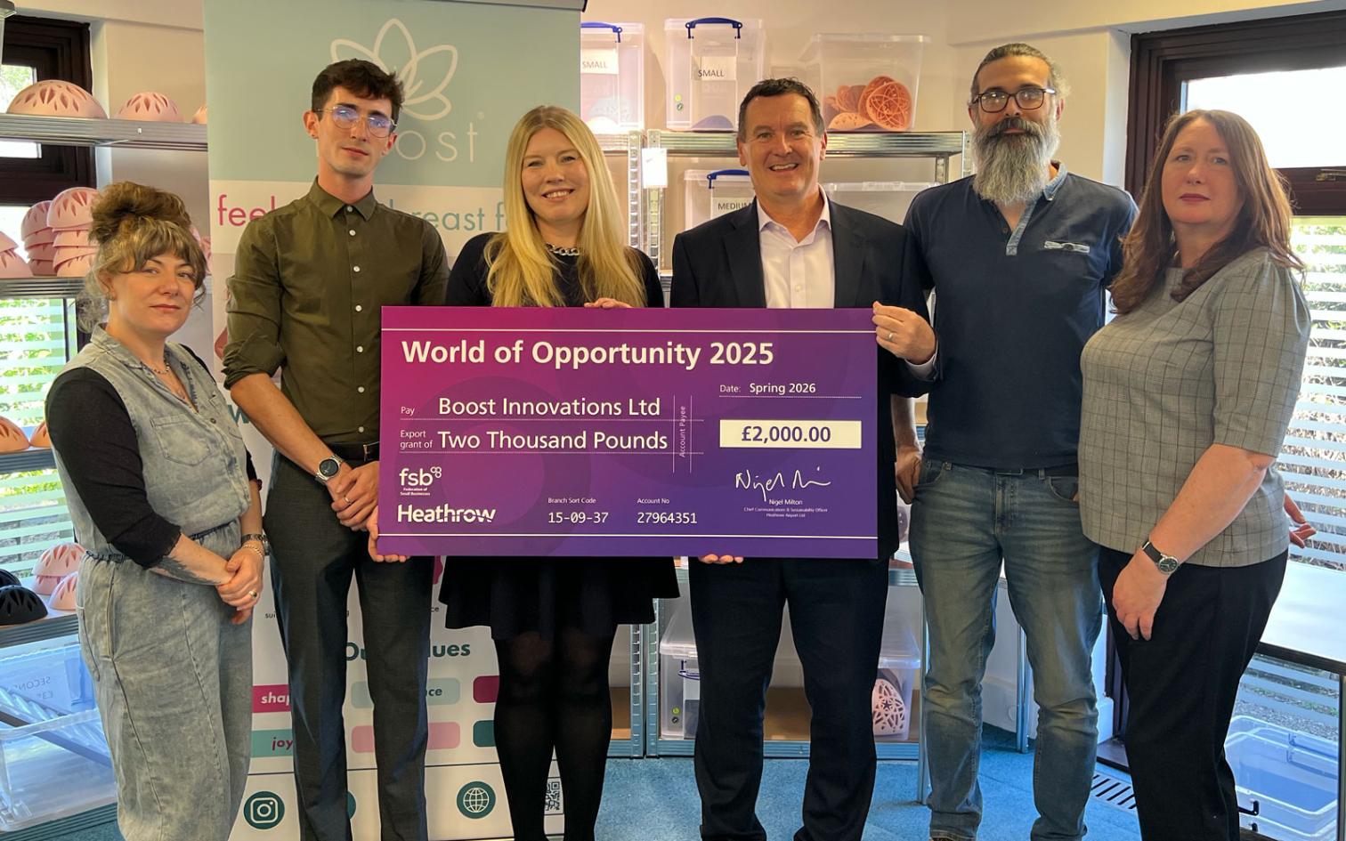 WUKA - collecting the grant check from Heathrow representitive