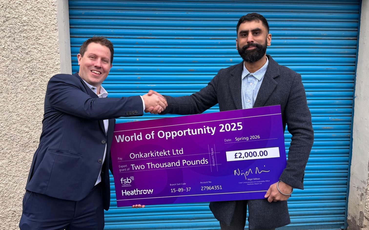 Onkarkitekt Ltd - collecting the grant check from Heathrow representitive