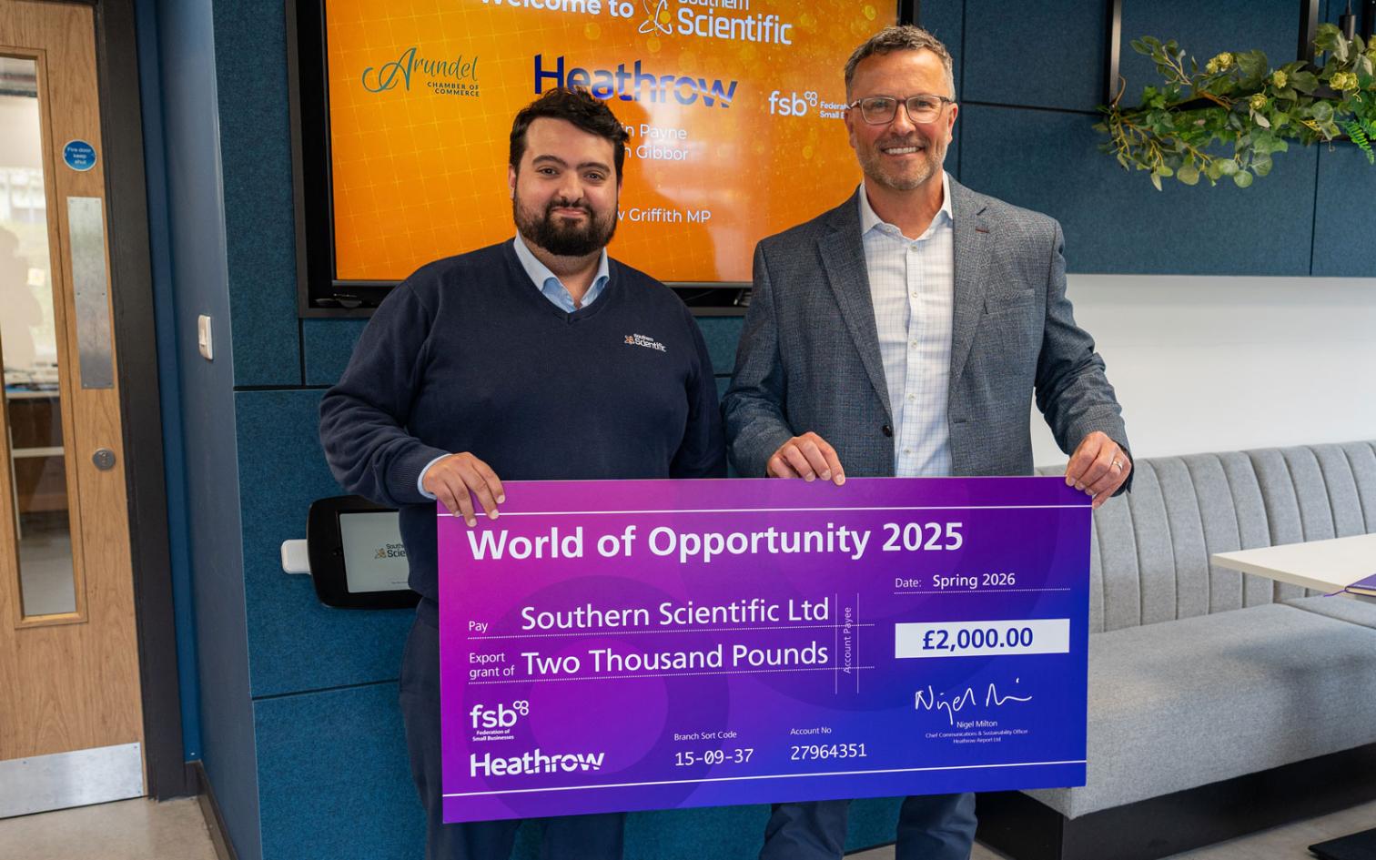 Southern Scientific - collecting the grant check from Heathrow representitive