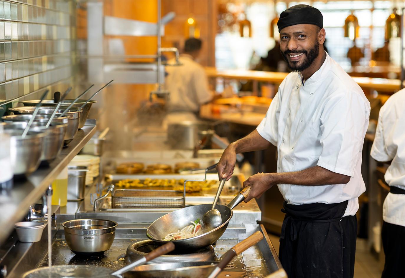 Heathrow Academy student cooking in kitchen work environment