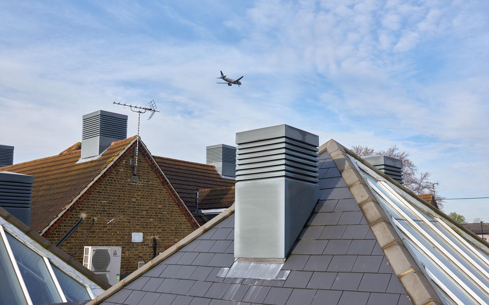 Plane flying above rooftops