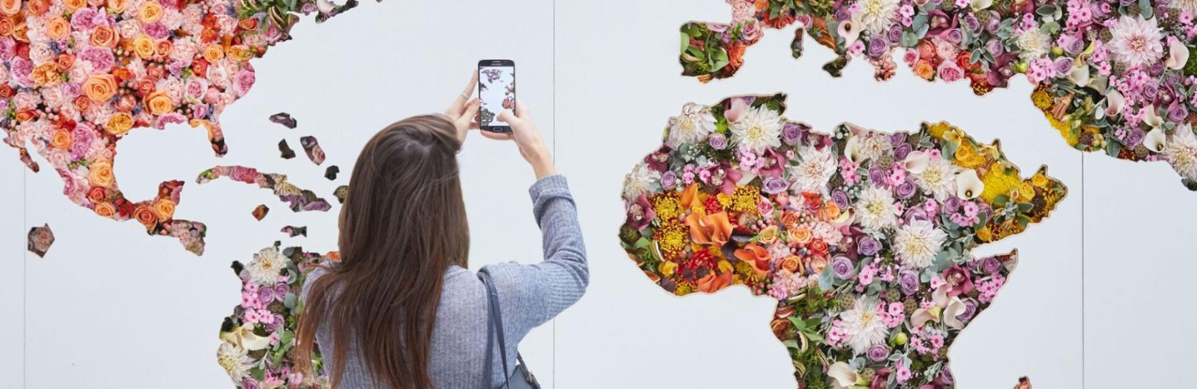 Lady taking picture of  a floral map