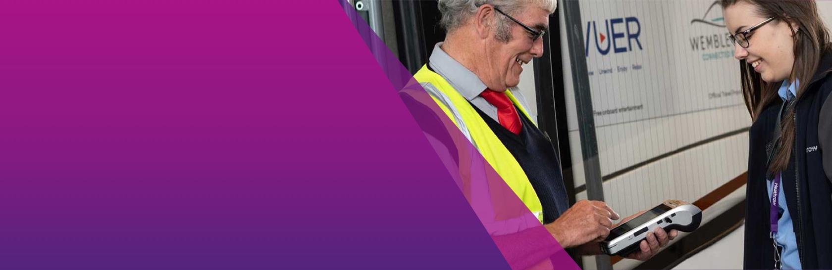 Two staff members smiling at each other 